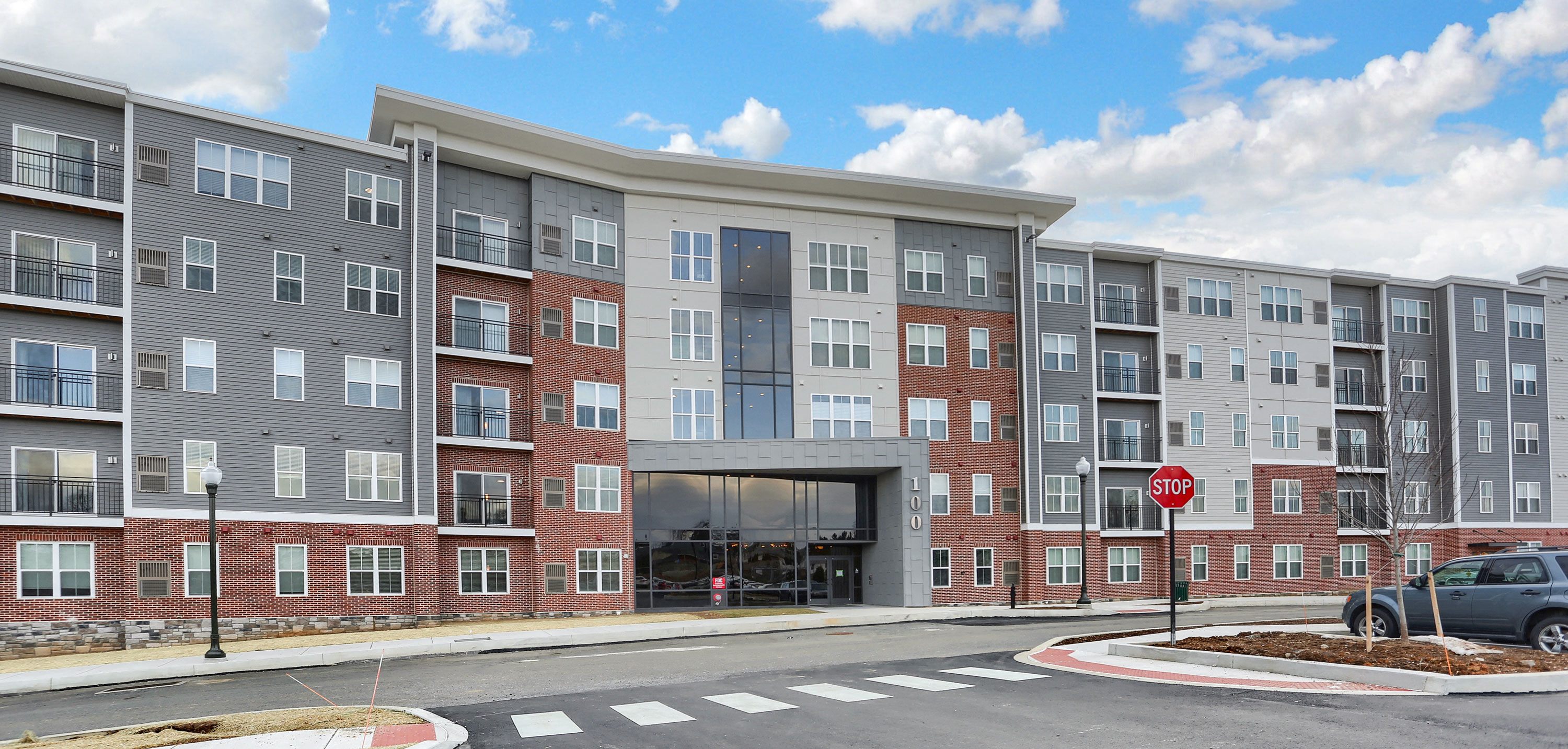 an exterior view of an apartment building on a city street